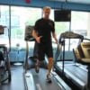 A man demonstrates how to complete a walking backwards routine on a treadmill.