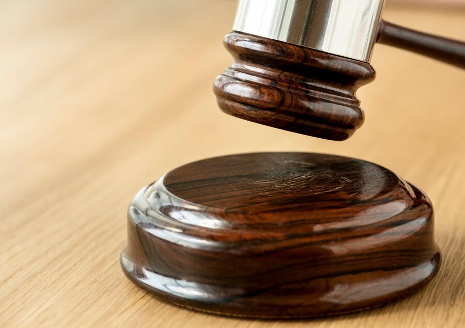 A close up photograph of a wooden judge’s gavel